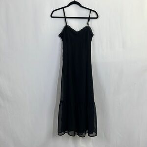 Fitted black spaghetti strap dress and corset and ruffle detail and tiered skirt